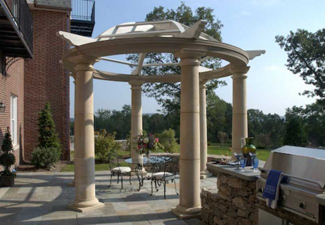 This reproduction antique shade arbor provides a dramatic focal point on this dining terrace.